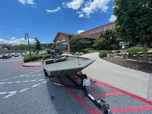 Slide: The Image of 2024 Tracker Grizzly 2072 CC boat on trailer outside Tracker Boats dealership. - 2