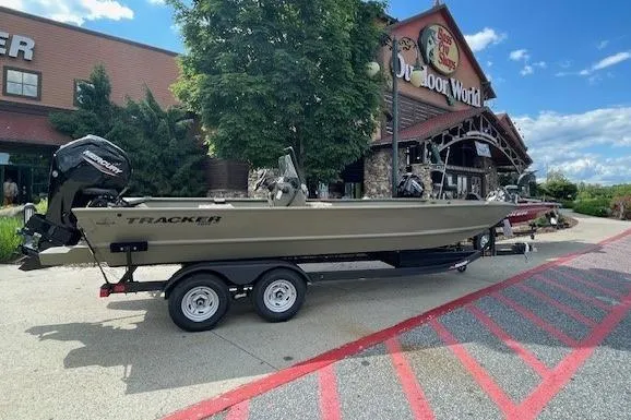 Slide: The Image of 2024 Tracker Grizzly 2072 CC boat on trailer outside Bass Pro Shops. - 5