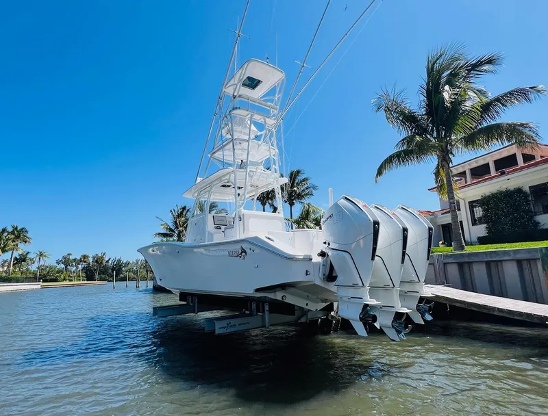 Slide: The Image of 2015 Billfish 39 Custom CC boat docked by a waterfront property. - 11