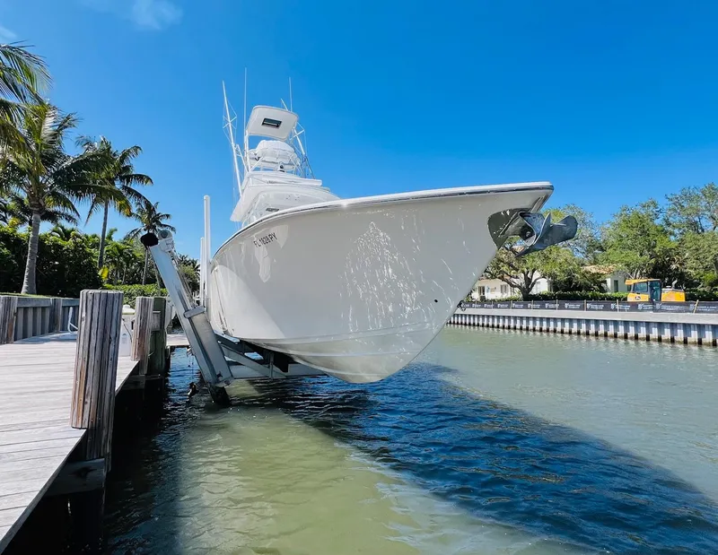 Slide: The Image of 2015 Billfish 39 Custom CC boat docked on a lift in a sunny marina. - 13