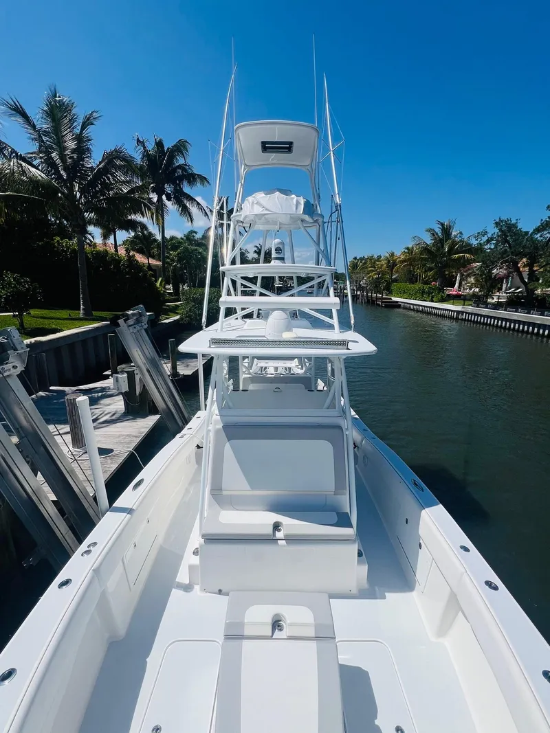 Slide: The Image of 2015 Billfish 39 Custom CC boat docked by a canal on a sunny day. - 20
