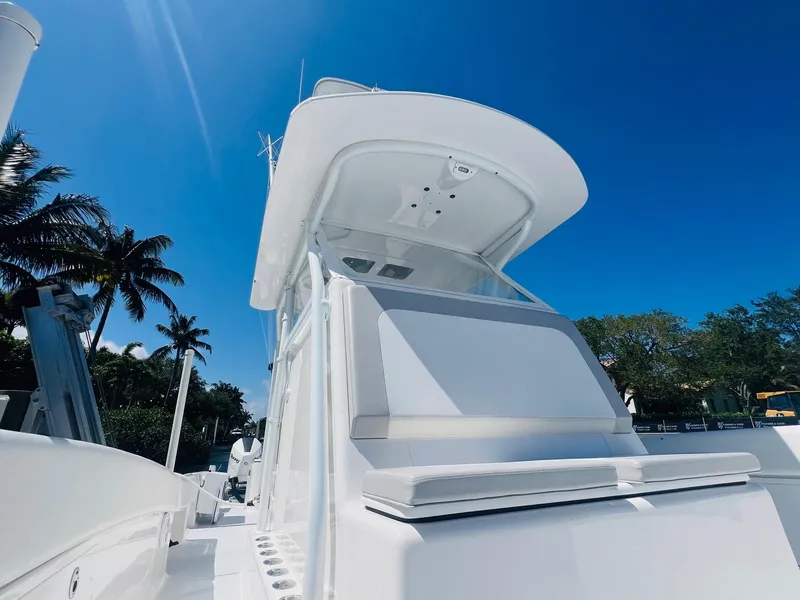 Slide: The Image of 2015 Billfish 39 Custom CC boat under clear blue sky with palm trees. - 24