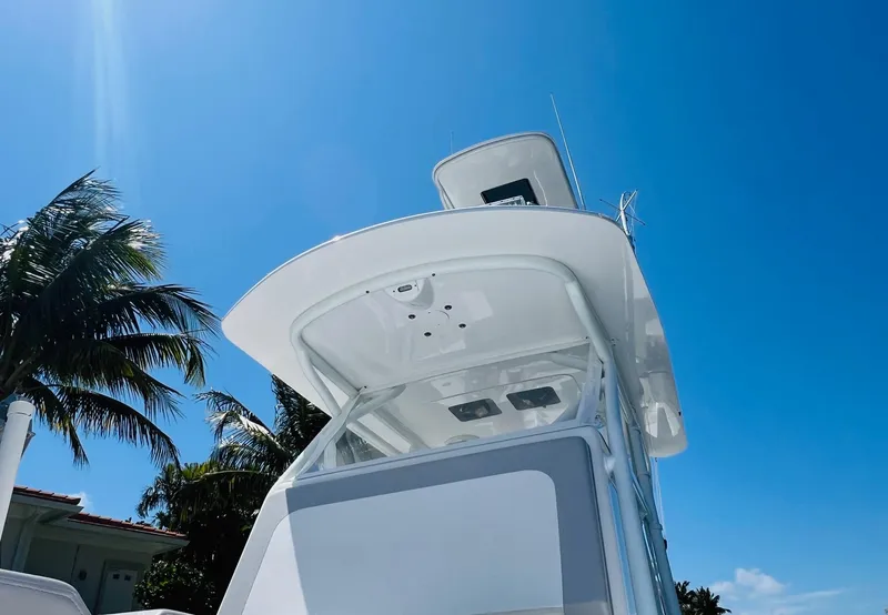 Slide: The Image of 2015 Billfish 39 Custom CC boat under clear blue sky with palm trees. - 28