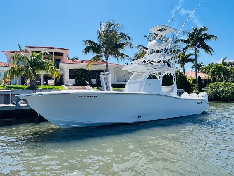 Slide: The Image of 2015 Billfish 39 Custom CC boat docked near a waterfront home. - 3