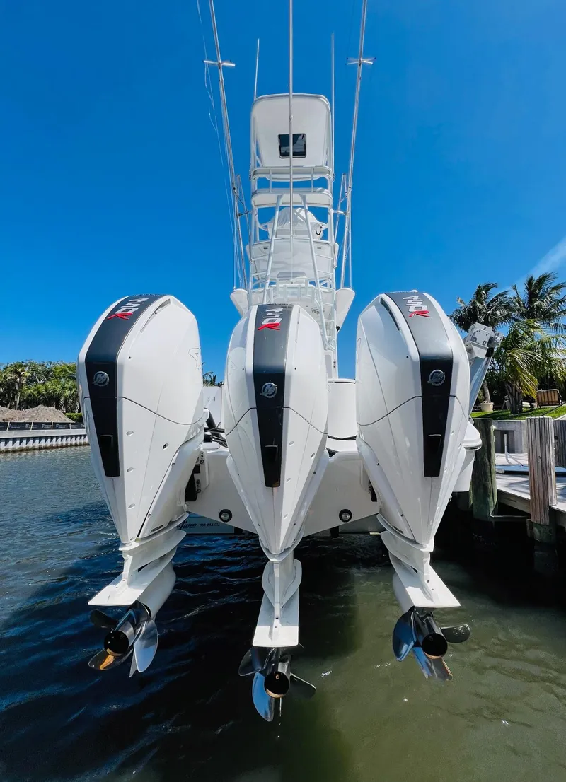 Slide: The Image of 2015 Billfish 39 Custom CC boat with triple outboard engines docked. - 33