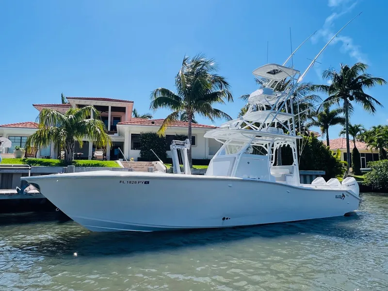 Slide: The Image of 2015 Billfish 39 Custom CC boat docked near a waterfront home. - 4