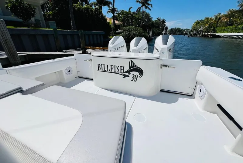 Slide: The Image of Billfish 39 Custom CC 2015 boat interior with triple outboard engines, docked by a canal. - 47