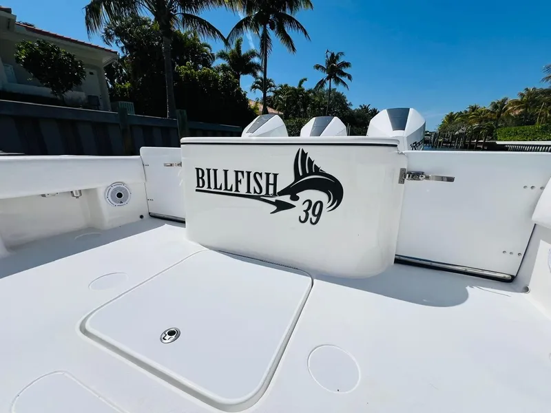 Slide: The Image of 2015 Billfish 39 Custom CC boat deck with logo, palm trees in background. - 48