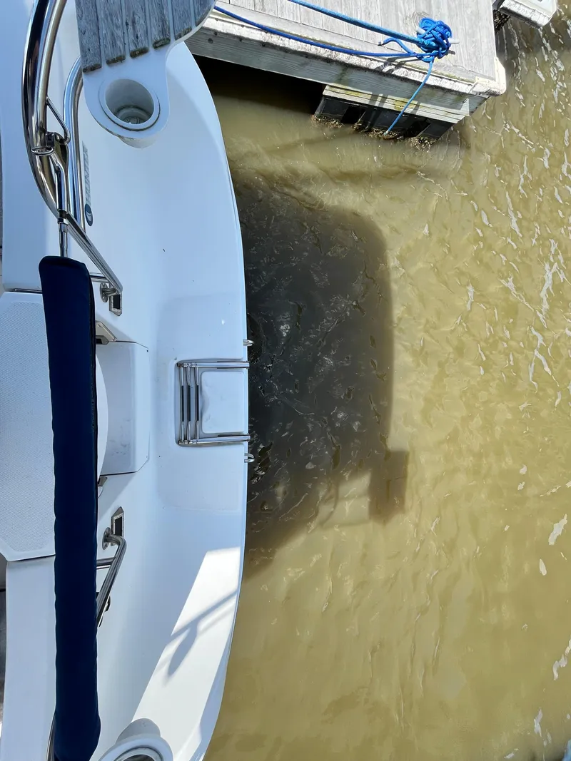 Slide: The Image of Top view of a 2005 Hunter 31 boat docked on murky water. - 10