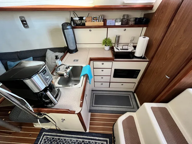 Slide: The Image of Compact kitchen in 2005 Hunter 31 sailboat with sink, coffee maker, and microwave. - 12
