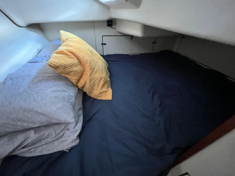 Slide: The Image of Cozy cabin bed in 2005 Hunter 31 sailboat with pillows and dark bedding. - 15