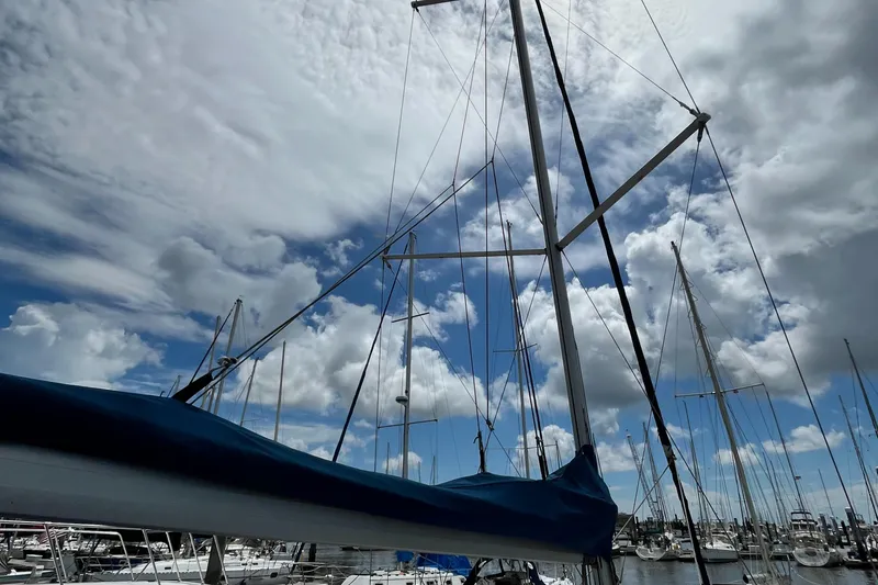 Slide: The Image of Sailboat mast against cloudy sky, Hunter 31 model, 2005, in marina setting. - 18