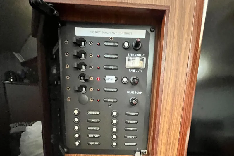 Slide: The Image of Electrical control panel on a 2005 Hunter 31 boat, featuring various switches and indicators. - 19