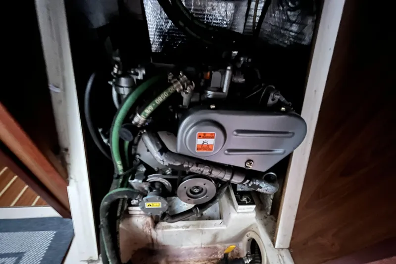 Slide: The Image of Engine compartment of a 2005 Hunter 31 sailboat, featuring hoses and mechanical components. - 21