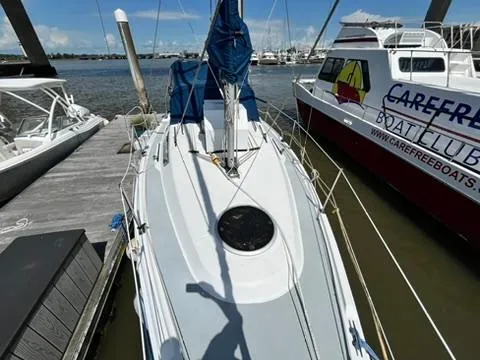 Slide: The Image of 2005 Hunter 31 sailboat docked at marina, sunny day, adjacent to Carefree Boat Club vessel. - 4