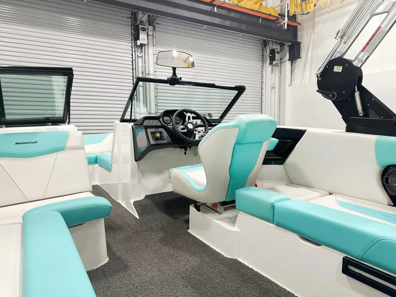 Slide: The Image of 2020 MasterCraft NXT 22 boat interior with turquoise and white seating, modern dashboard. - 5