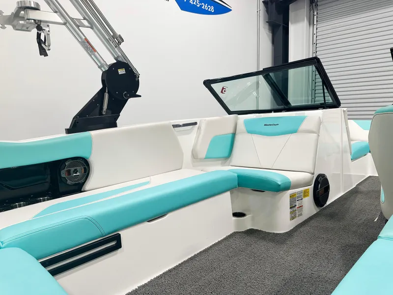 Slide: The Image of 2020 MasterCraft NXT 22 boat interior with teal and white seating. - 6