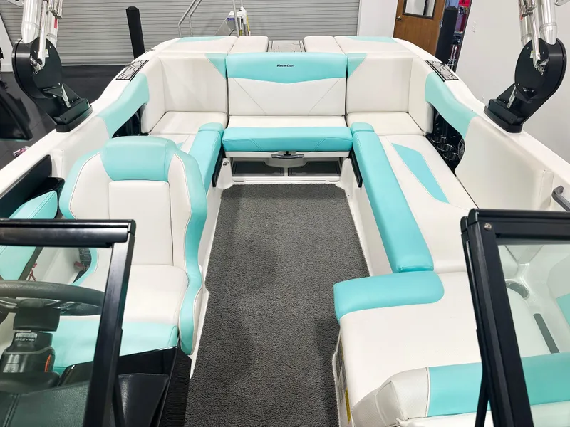 Slide: The Image of 2020 MasterCraft NXT 22 boat interior with white and turquoise seating. - 8