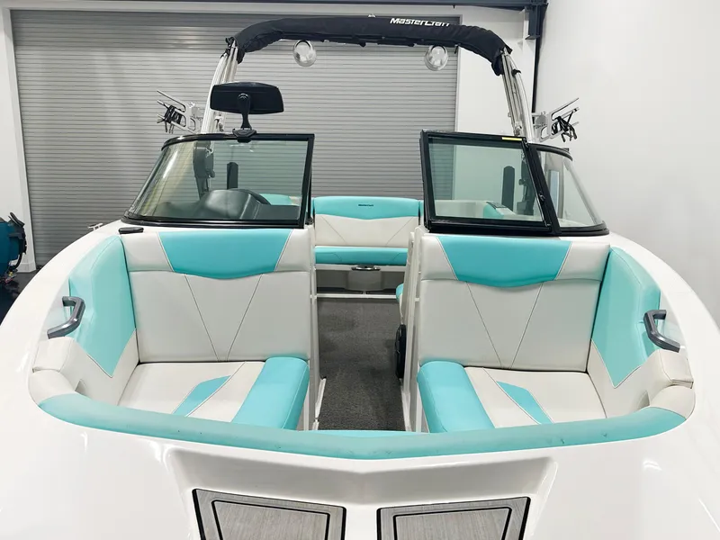 Slide: The Image of 2020 MasterCraft NXT 22 boat interior with turquoise and white seating. - 9