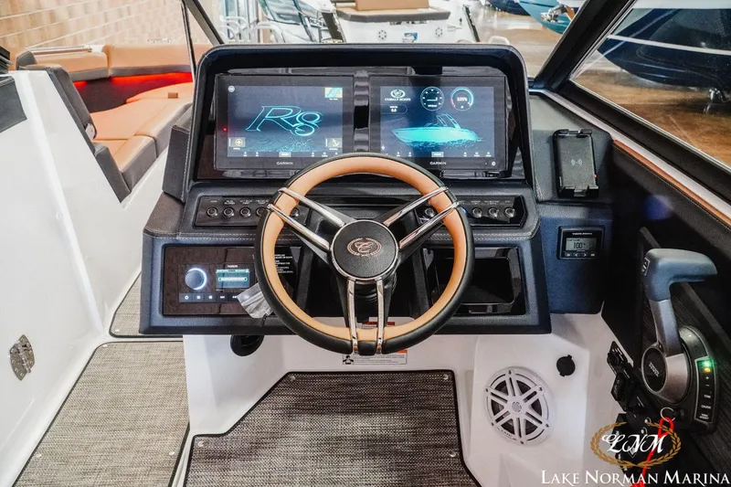Slide: The Image of Cobalt R8 2023 boat dashboard with modern touchscreen controls and steering wheel at Lake Norman Marina. - 11