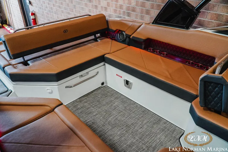 Slide: The Image of 2023 Cobalt R8 boat interior with brown leather seating and carpeted flooring. - 17