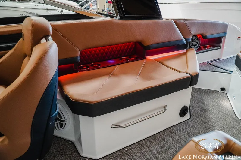 Slide: The Image of 2023 Cobalt R8 boat interior with brown leather seats and red accent lighting. - 18