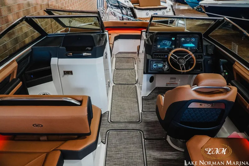 Slide: The Image of 2023 Cobalt R8 boat interior with modern dashboard and leather seating at Lake Norman Marina. - 9