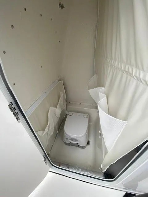Slide: The Image of 2024 Key West 219 FS boat interior with portable toilet. - 11