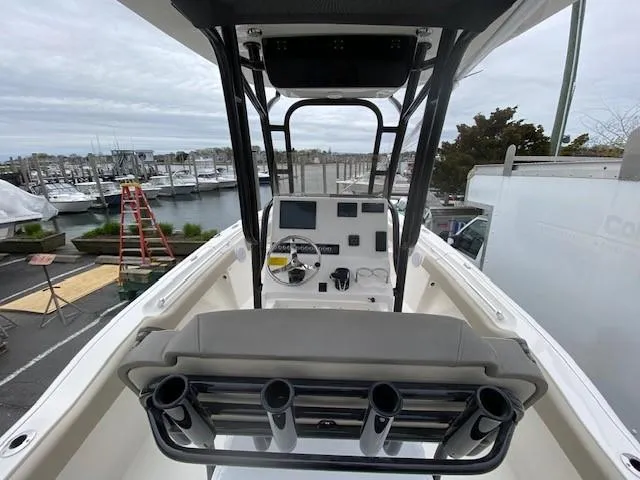Slide: The Image of 2024 Key West 219 FS boat console and seating at a marina. - 4