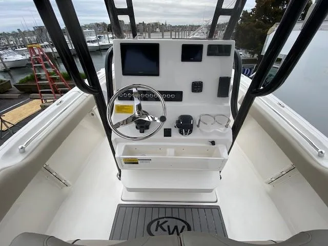 Slide: The Image of 2024 Key West 219 FS boat console with steering wheel and navigation screens. - 5