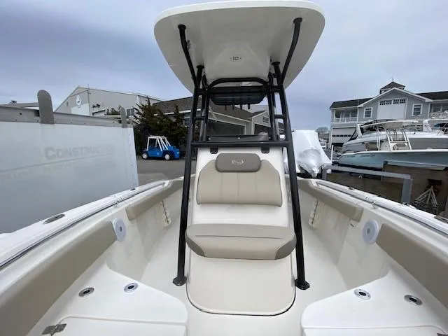 Slide: The Image of 2024 Key West 219 FS boat interior with seating and T-top in marina. - 7