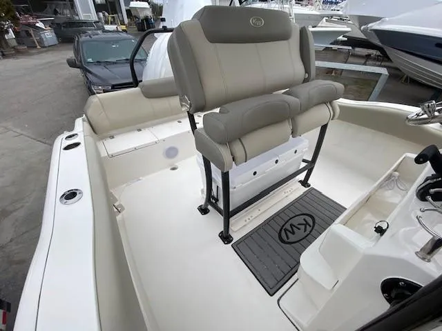 Slide: The Image of 2024 Key West 219 FS boat interior with cushioned seating and console. - 8