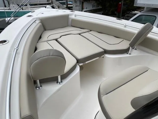 Slide: The Image of 2024 Key West 219 FS boat with cushioned seating area. - 9