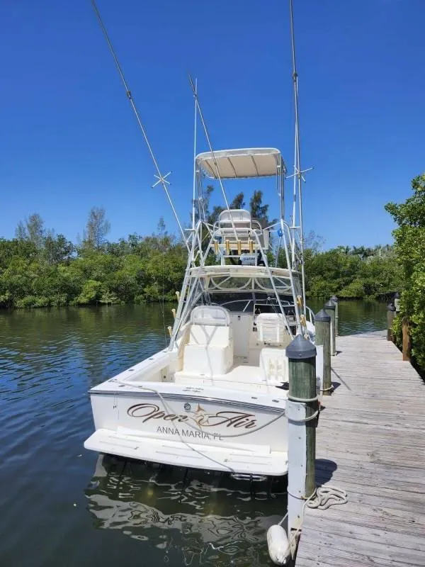 Slide: The Image of 2002 Albemarle 285 Express Fisherman docked by lush greenery. - 1