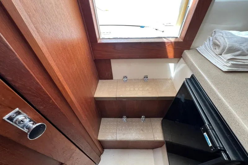 Slide: The Image of Interior of 2002 Albemarle 285 Express Fisherman with steps, window, and compact fridge. - 10