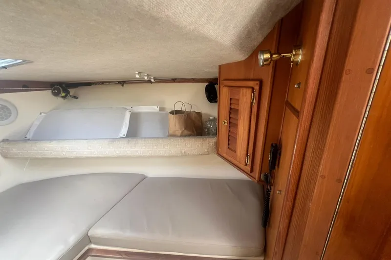 Slide: The Image of Interior cabin of 2002 Albemarle 285 Express Fisherman with wooden cabinetry and seating. - 14