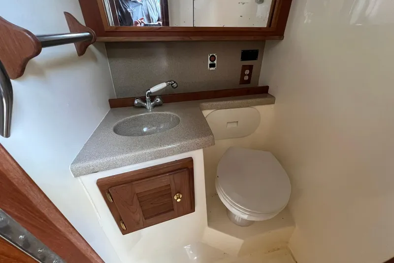 Slide: The Image of 2002 Albemarle 285 Express Fisherman boat bathroom with sink, mirror, and toilet. - 17