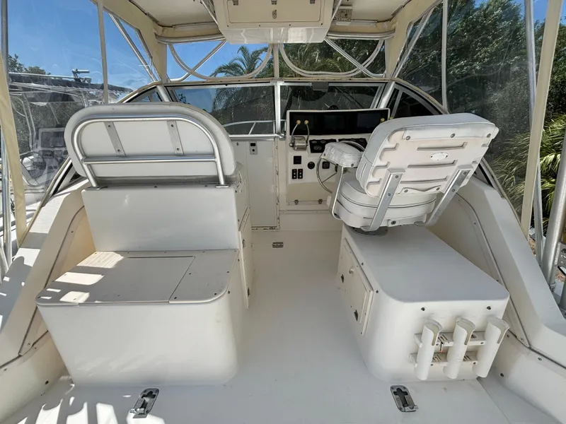 Slide: The Image of 2002 Albemarle 285 Express Fisherman boat cockpit with helm and seating. - 3