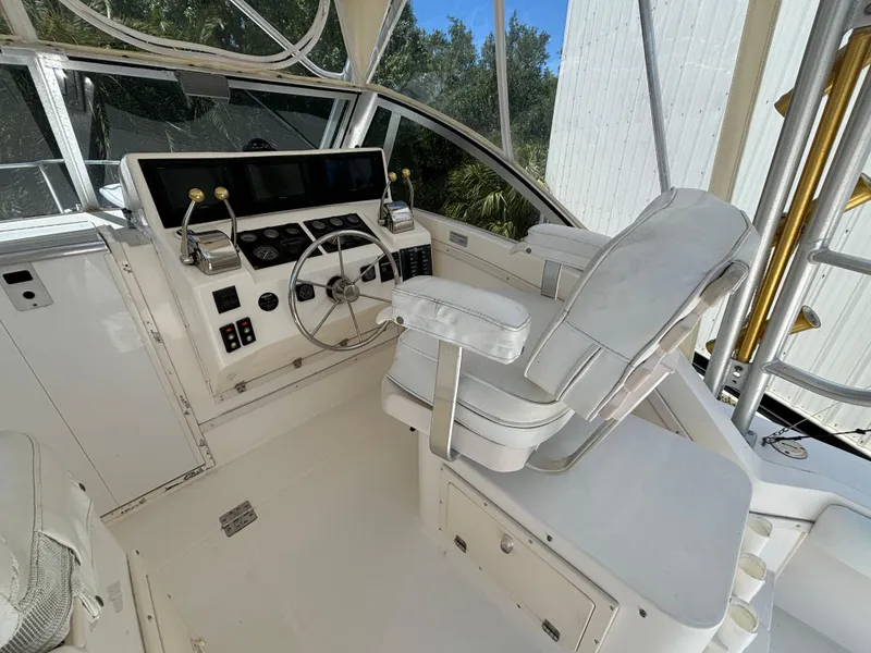 Slide: The Image of 2002 Albemarle 285 Express Fisherman boat cockpit with captain's chair and control panel. - 5