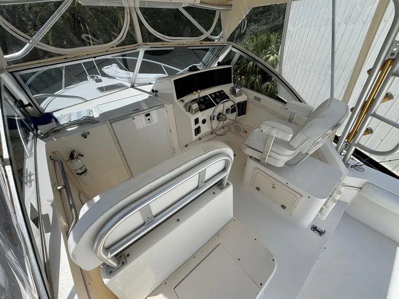 Slide: The Image of 2002 Albemarle 285 Express Fisherman boat cockpit with helm and seating. - 6