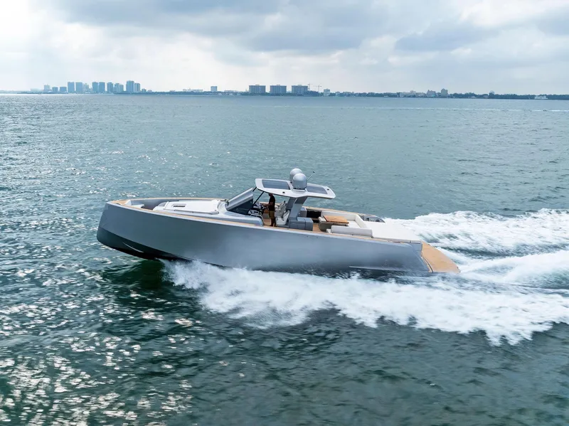 Slide: The Image of 2023 Pardo Yachts 50 cruising on open water with city skyline in background. - 16