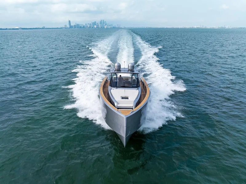 Slide: The Image of 2023 Pardo Yachts 50 cruising on open water with city skyline in background. - 24