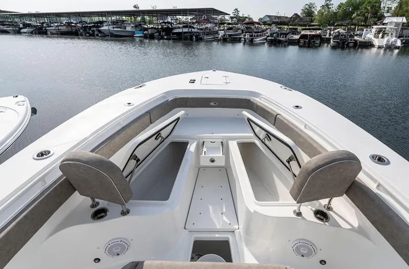 Slide: The Image of 2025 Sea Hunt GAMEFISH 28 boat interior with open storage compartments at marina. - 4