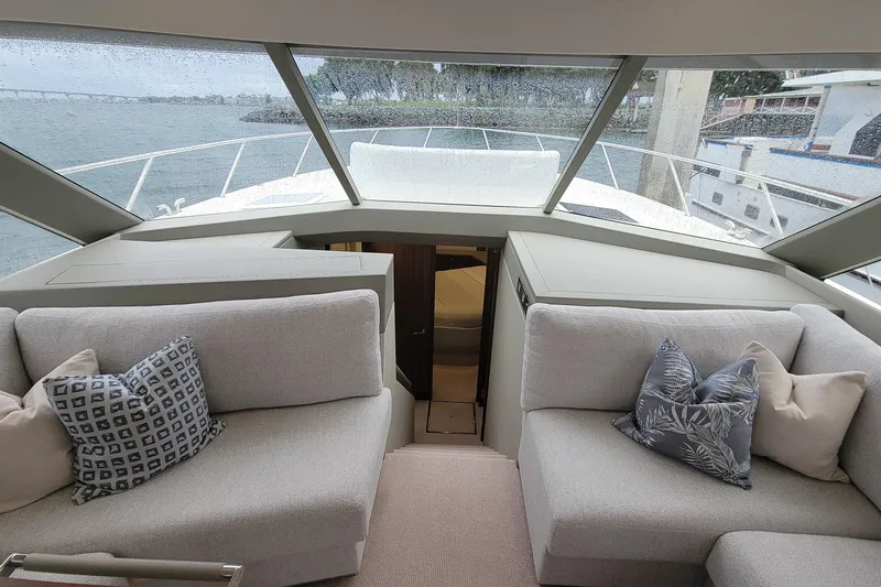 Slide: The Image of Interior of 2026 Maritimo M55 yacht with plush seating and scenic window view. - 18