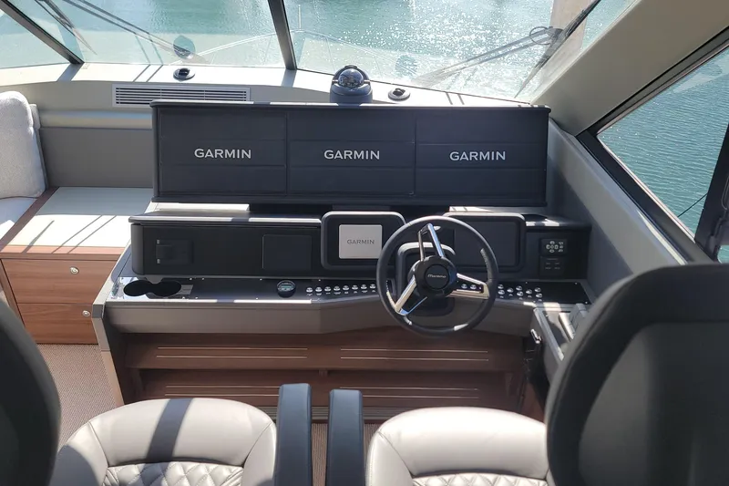 Slide: The Image of 2026 Maritimo M55 yacht helm with Garmin navigation displays and modern steering wheel. - 29
