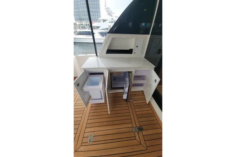 Slide: The Image of 2026 Maritimo M55 yacht interior with open storage cabinets on teak deck. - 35