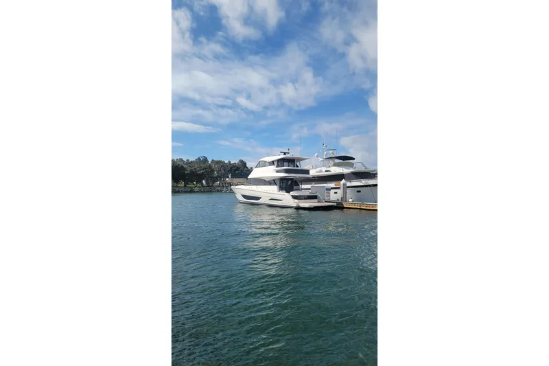 Slide: The Image of 2026 Maritimo M55 yacht docked on a sunny day with blue skies. - 36