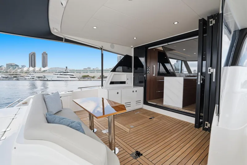Slide: The Image of Luxury Maritimo M55 yacht deck with modern seating and city skyline, 2026 model. - 45