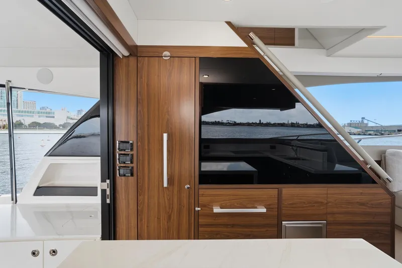 Slide: The Image of Luxurious interior of 2026 Maritimo M55 yacht with sleek wood finishes and waterfront view. - 52