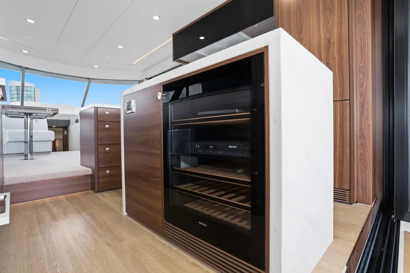 Slide: The Image of Luxurious interior of 2026 Maritimo M55 yacht featuring modern cabinetry and wine cooler. - 55